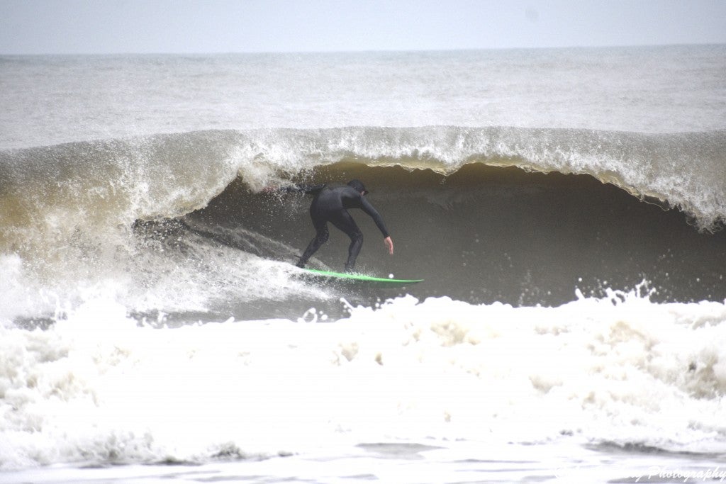 Surfer Shawn Clark ducks under another ave curl at